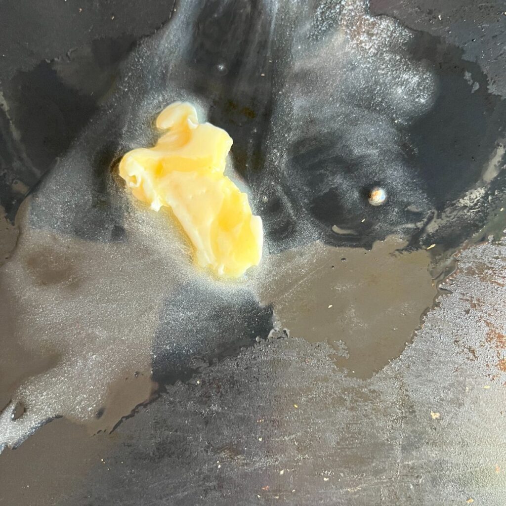 Butter melting on a Blackstone. 