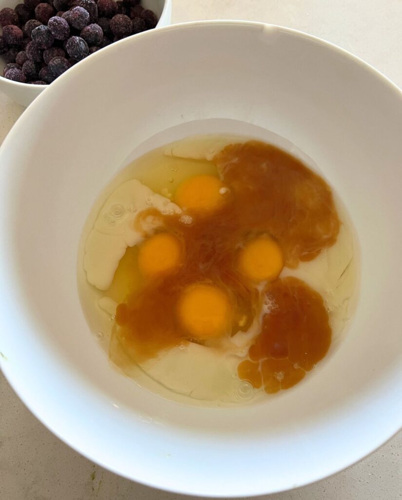 Eggs, milk, and vanilla mixed together in a bowl. 